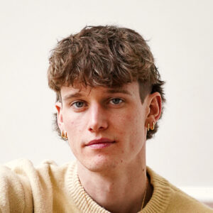 Etienne Yvelin smiles close up with a relaxed expression.